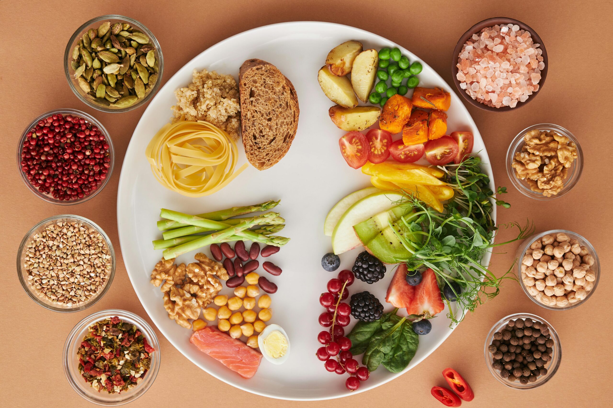 A vibrant assortment of healthy foods on a plate, showcasing a balanced diet with fruits, vegetables, nuts, and grains.